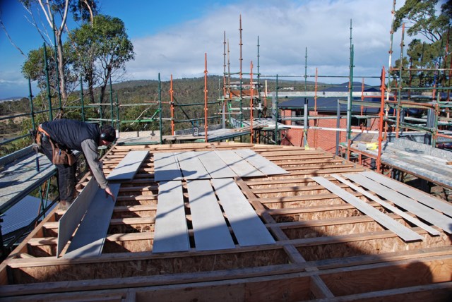 First the fibre cement sheets mist be measured and cut to size to fit in the gaps and rest on top of the lower flanges of the I-beams.