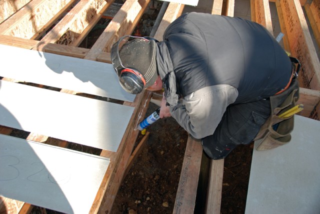 Jib lays a bead of glue on all around the lower flange before placing the sheet in the gap on top of the flanges.