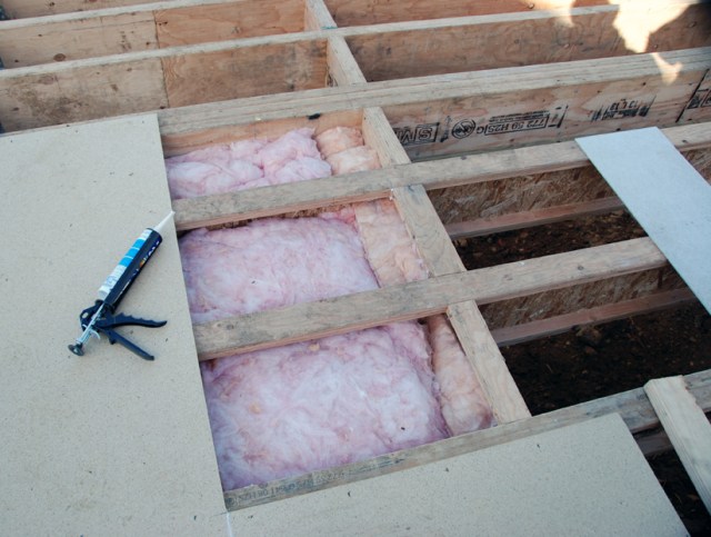 The R5 insulation is then stuffed snugly into the compartments before the subflooring is laid, closing it all up.
